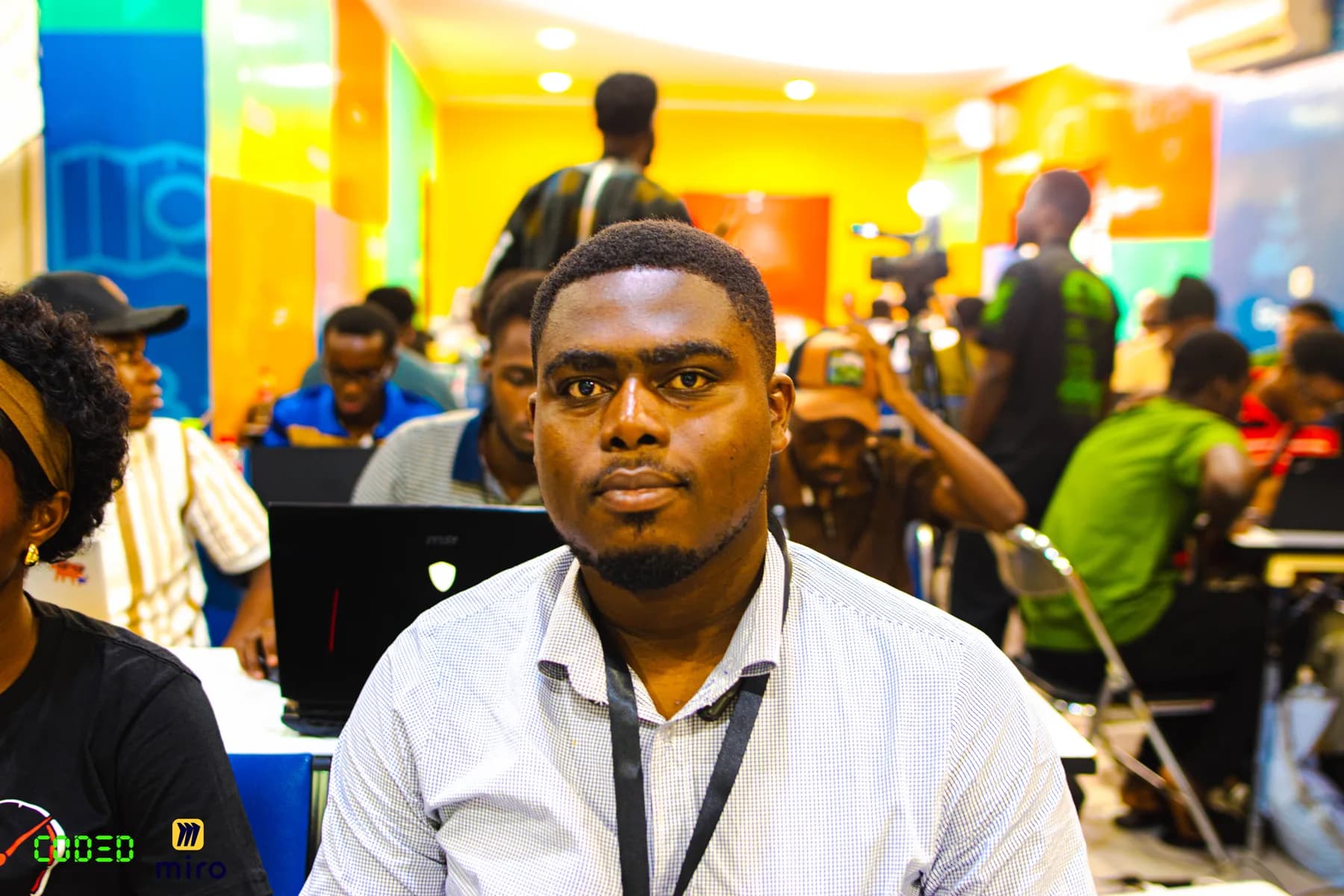 An attendee with other builders working in the background